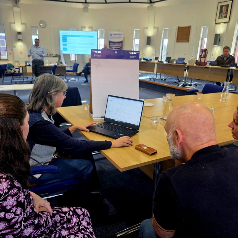 A Group of people working on laptops at a GovAssist Event