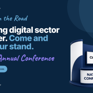 A promotional banner for CloudyIT's presence at the ADSO Annual Conference, part of the "Cloudy on the Road" in-person event series. The background is dark navy blue with a vertical light blue bar on the far left that reads "CLOUDYIT EVENTS." On the left, the main headline reads, "Leading digital sector partner. Come and visit our stand." Below this, the event name "ADSO Annual Conference" is written in a purple handwritten-style font. A light blue badge indicates "National Conferences," and a Microsoft Solutions partner logo sits in the bottom left corner. On the right is a 3D illustration of an exhibition stand. The stand features a screen displaying the CloudyIT logo and a front counter that reads "NATIONAL CONFERENCES." Glowing digital lines connect the screen to four floating 3D icons: a speech bubble, a handshake, a laptop, and a presentation whiteboard.